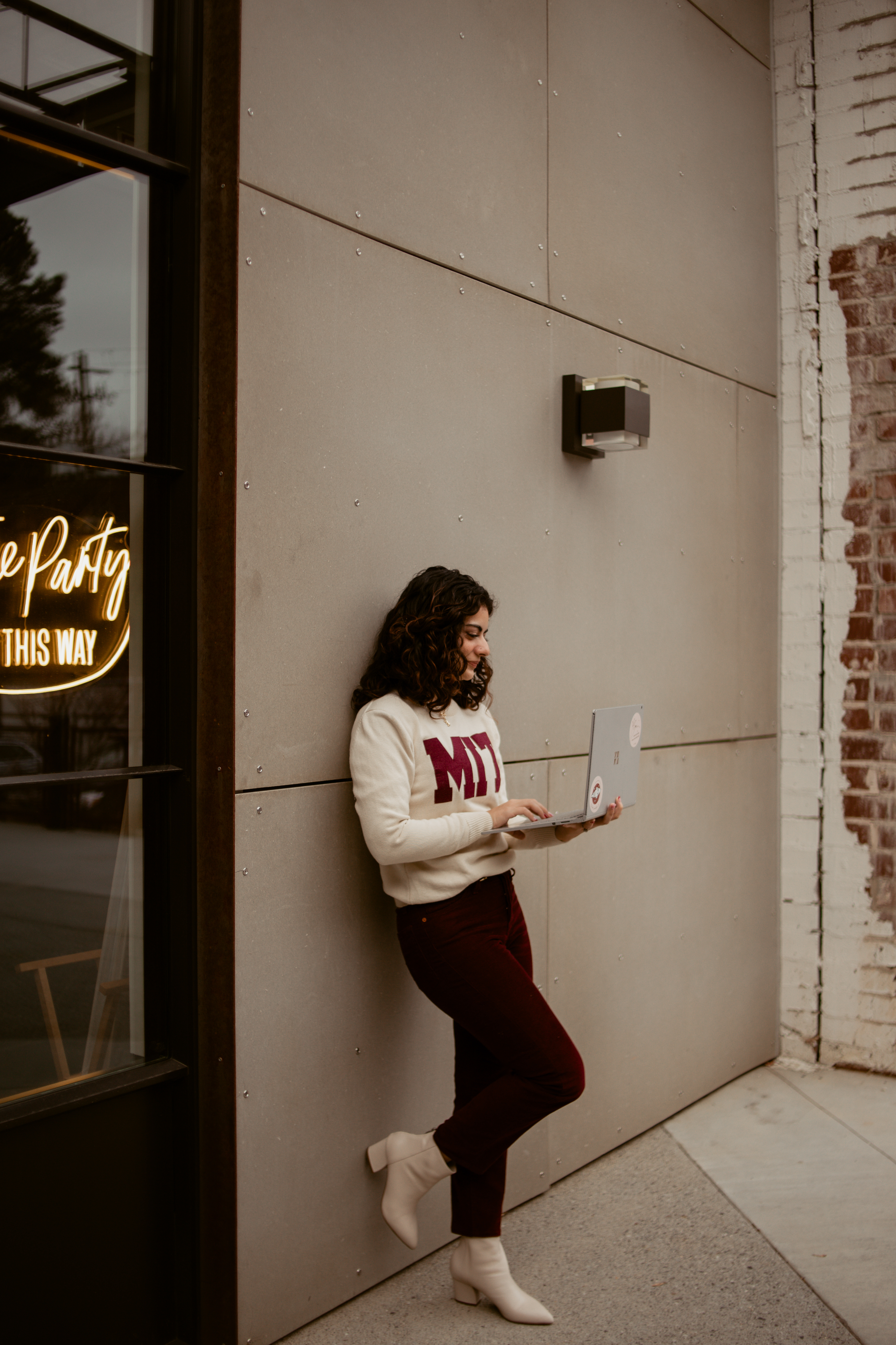 Woman in MIT sweater working on her resume